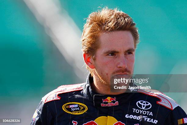 Scott Speed, driver of the Red Bull Toyota, stands on pit road during qualifying for the NASCAR Sprint Cup Series Price Chopper 400 on October 1,...