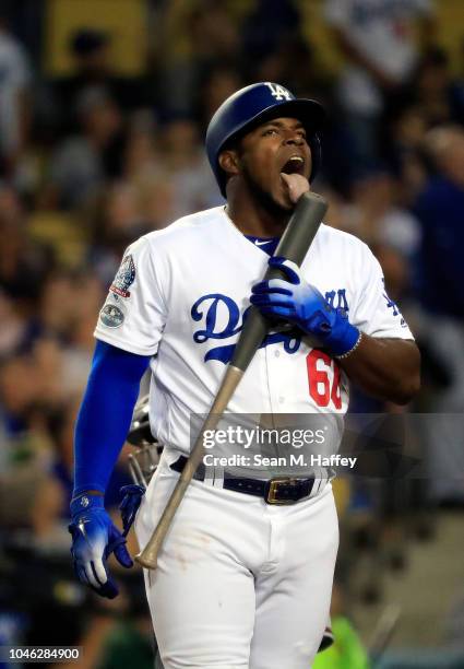 Yasiel Puig of the Los Angeles Dodgers licks his bat during the fourth inning against the Atlanta Braves during Game Two of the National League...