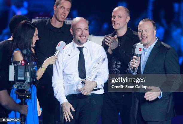 Der Graf of the band Unheilig from North Rhine-Westphaliareceives his award from contest hosts Stefan Raab and Johanna Klum after winning first place...