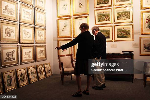 People look at art and antiques at the Avenue Antiques & Art at the Armory on October 1, 2010 in New York City. The Avenue Antiques & Art at the...