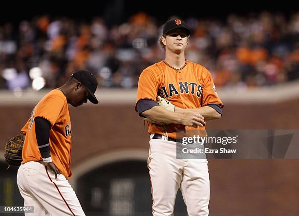 Matt Cain and Edgar Renteria of the San Francisco Giants wait for manager Bruce Bochy to come to the mound to take Cain out of their game against the...