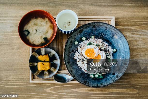 flat lay of delicate japanese meal with appetizer, miso soup and tea freshly served on table in a restaurant - japanese food stock pictures, royalty-free photos & images