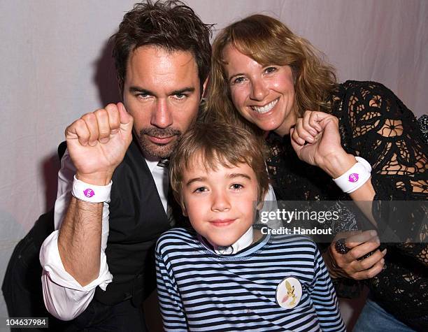 In this handout photo provided by The Hub, Actor Eric McCormack, son Finnigan McCormack and wife Janet McCormack pose with watches at The Hub TV...