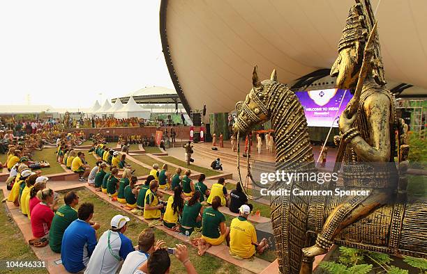 Australian athletes watch entertainment on stage during an Australian team Flag Raising ceremony at the Athletes Media Village ahead of the Delhi...