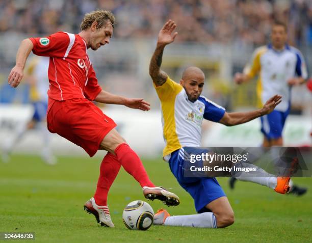 Peter Schyrba of Rostock and Orlando Smeekes of Jena fight for the ball during the Third League match between Carl Zeiss Jena and Hansa Rostock at...