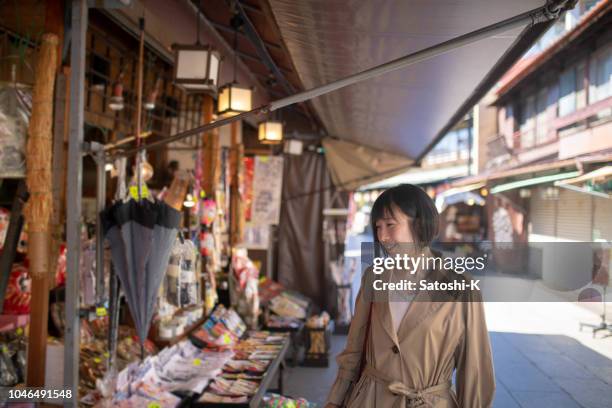 asian woman walking in traditional japanese town - shitamachi stock pictures, royalty-free photos & images