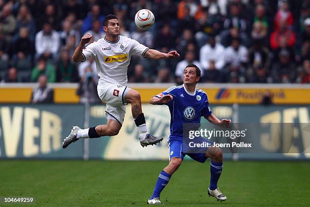 Raul Bobadilla of Borussia and Marcel Schaefer of Wolfsburg battle for the ball during the Bundesliga match between Borussia M'gladbach and VfL...