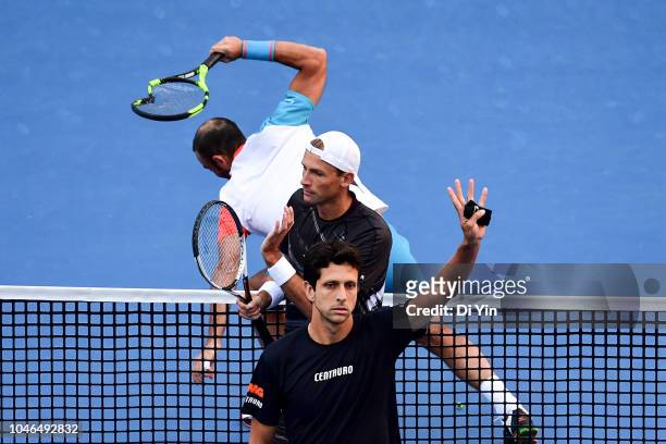 Lukasz Kubot of Poland and Marcelo Melo of Brazil celebrates after win while opponent thow his tennis rackets on the field during their Men's Doubles...