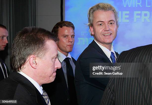 Dutch right-wing politician Geert Wilders , flanked by body guards, departs after speaking to supporters on October 2, 2010 in Berlin, Germany....