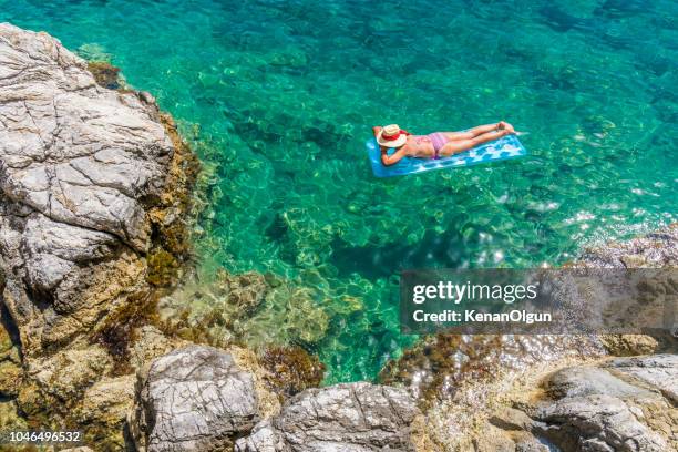 women is sunbathing on the seabed. - one young woman only stock pictures, royalty-free photos & images
