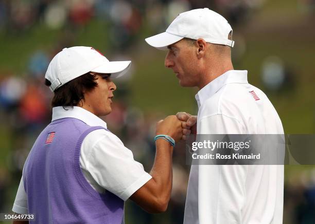 Rickie Fowler of the USA is congratulated by Jim Furyk on the 18th green after they halved their match during the rescheduled Afternoon Foursome...