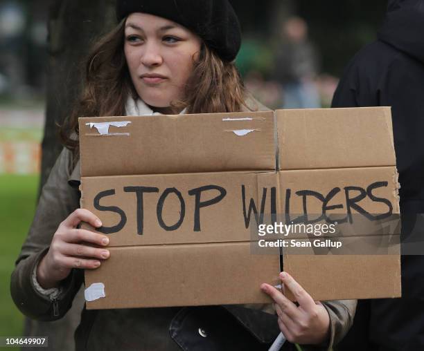 Young woman joins protesters outside a hotel where Dutch right-wing politician Geert Wilders spoke to supporters on October 2, 2010 in Berlin,...