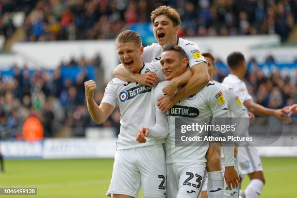 George Byers, Daniel James and Connor Roberts of Swansea City celebrate their team's opening goal during the Sky Bet Championship match between...