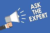 Text sign showing Ask The Expert. Conceptual photo Looking for professional advice Request Help Support Man holding megaphone loudspeaker blue background message speaking loud.