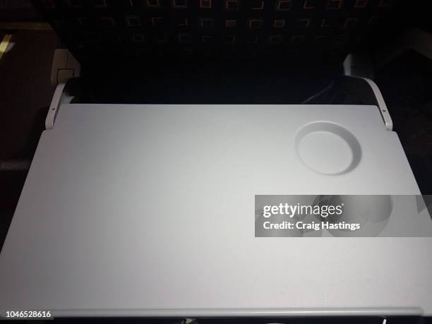 shot of tray table down on economy flight night highlight plain clear airline - airplane tray table stock pictures, royalty-free photos & images