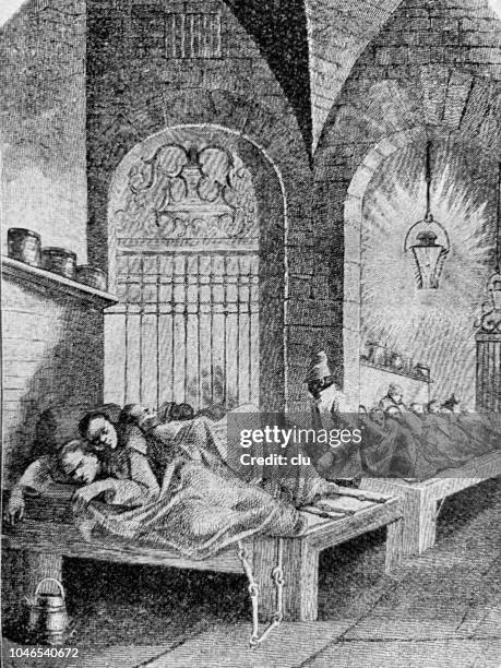 inside prison, men lying on planks, chained up, 1802 - chained stock illustrations