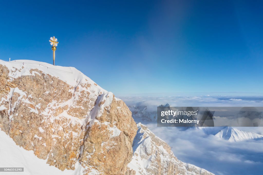 Cross on the summit of Mount Zugspitze. Wetterstein mountains, Bavaria, Germany.