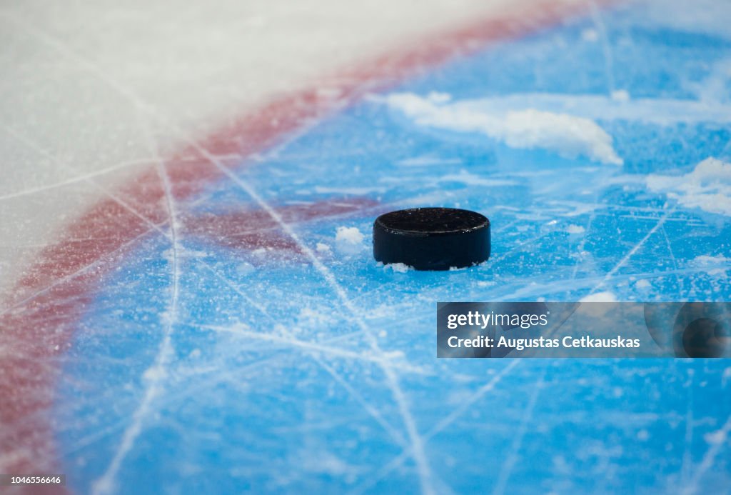 Close-Up Of Hockey Puck In Ice Rink