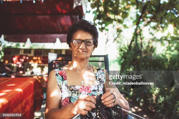 grandma and her life - old granny knitting stock pictures, royalty-free photos & images
