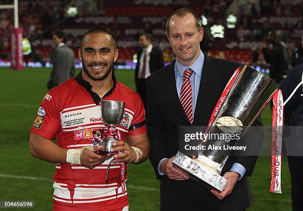 Michael Maguire the coach of Wigan Warriors lifts the engage Super League Grand Final trophy with Thomas Leuluai, the Man of the Match, after victory...