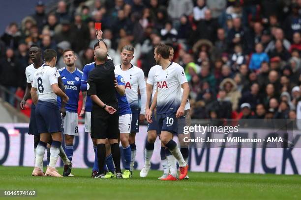 Joe Ralls of Cardiff City is shown a red card by match referee Mike Dean during the Premier League match between Tottenham Hotspur and Cardiff City...
