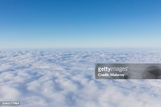 aerial view, above the clouds. clear blue sky - wolkengebilde stock-fotos und bilder