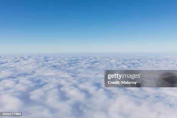 aerial view, above the clouds. clear blue sky - dessus photos et images de collection