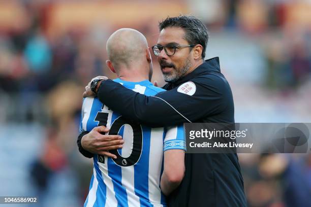 David Wagner, manager of Huddersfield Town speaks with Aaron Mooy of Huddersfield Town after the Premier League match between Burnley FC and...