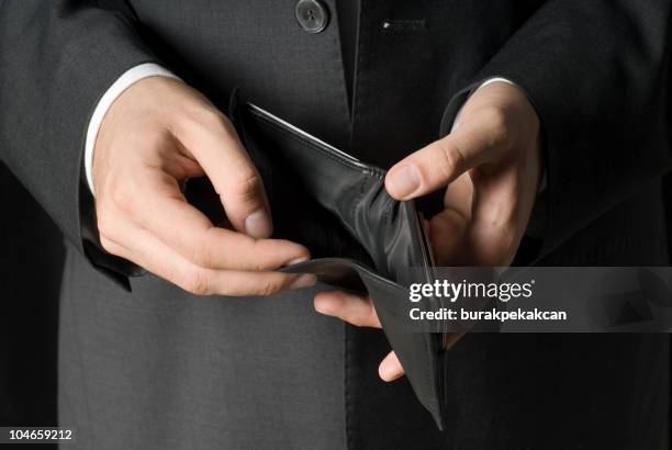 businessman showing empty wallet - man with empty wallet stock pictures, royalty-free photos & images
