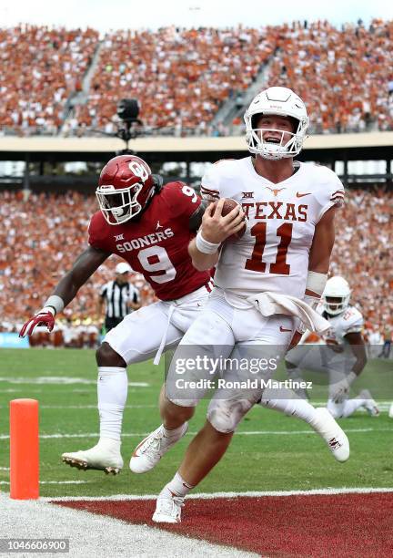 Sam Ehlinger of the Texas Longhorns smiles as he runs into the endzone for a touchdown against the Oklahoma Sooners in the second quarter of the 2018...