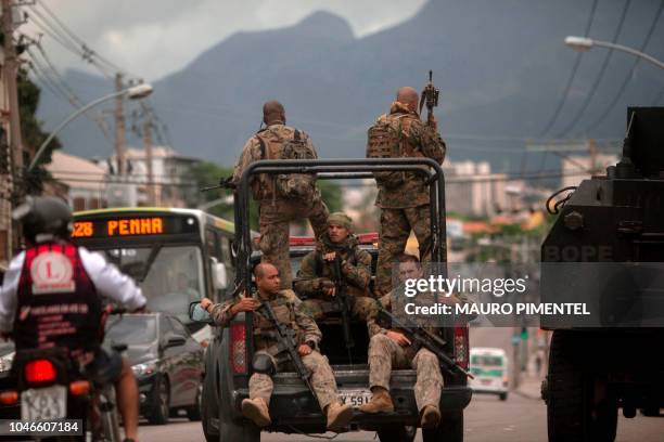 Rio de Janeiro's Special Police Unit members patrol during a security operation at Complexo do Alemao favela in Rio de Janeiro, Brazil, on October 06...