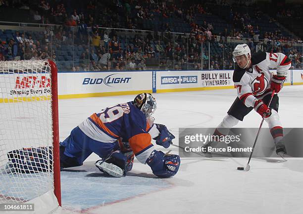 Rick DiPietro of the New York Islanders stops Ilya Kovalchuk of the New Jersey Devils on a penalty shot at the Nassau Veterans Memorial Coliseum on...