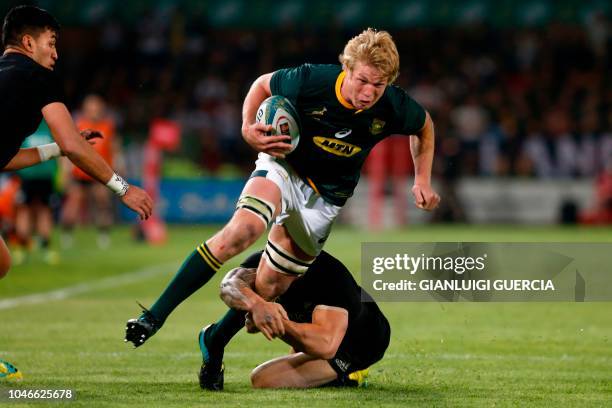 South Africa's lock Pieter-Steph du Toit is takled by New Zealand's left centre Sonny Bill Williams during the Rugby Championship match between South...