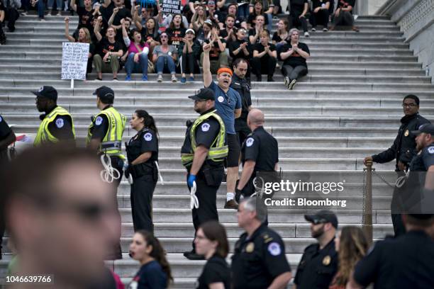 Demonstrator opposed to Supreme Court nominee Brett Kavanaugh is detained by U.S. Capitol police while protesting on the East Front of the U.S...