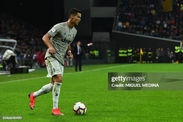 Juventus' Portuguese forward Cristiano Ronaldo controls the ball during the Italian Serie A football match Udinese Calcio vs Juventus FC at the Dacia...