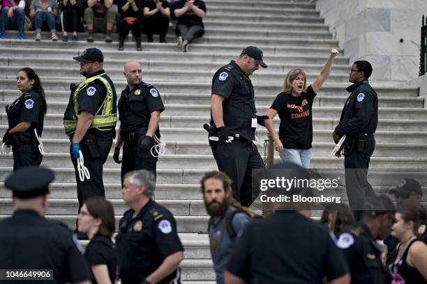Demonstrator opposed to Supreme Court nominee Brett Kavanaugh is detained by U.S. Capitol police while protesting on the East Front of the U.S...