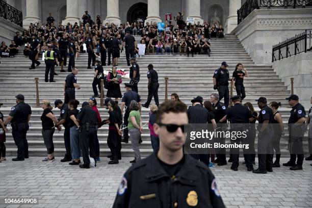 Demonstrators opposed to Supreme Court nominee Brett Kavanaugh are detained by U.S. Capitol police while protesting on the East Front of the U.S...