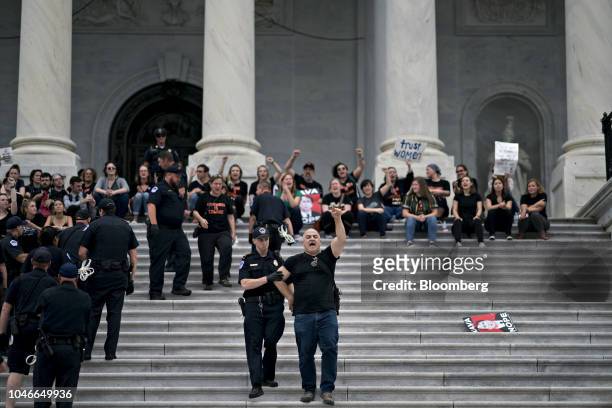 Demonstrator opposed to Supreme Court nominee Brett Kavanaugh is detained by U.S. Capitol police while protesting on the East Front of the U.S...