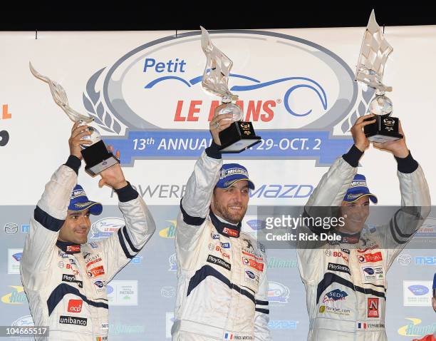 Pedro Lamy of Portugal, Franck Montagny of France and Stephane Sarrazin of France, drivers of the Team Peugeot Total Sport Peugeot 908 celebrate on...