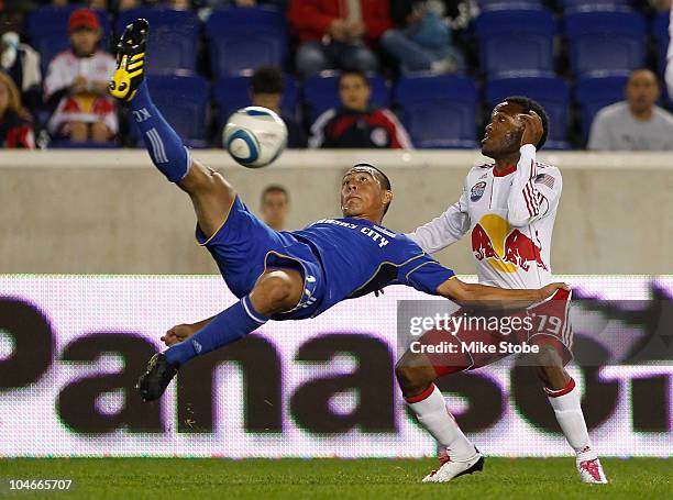 Roger Espinoza of the Kansas City Wizards challenges Dane Richards of the New York Red Bulls for the ball on October 2, 2010 at Red Bull Arena in...