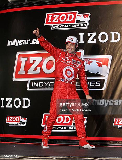Dario Franchitti of Scotland, driver of the Target Chip Ganassi Racing Dallara Honda, celebrates winning the IndyCar Championship during the Cafes do...