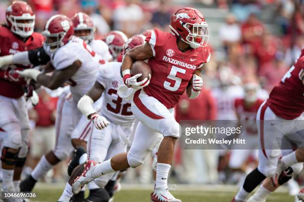 Rakeem Boyd of the Arkansas Razorbacks runs the ball in the second half during a game against the Alabama Crimson Tide at Razorback Stadium on...