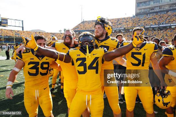 West Virginia Mountaineers players celebrate after the game against the Kansas Jayhawks at Mountaineer Field on October 6, 2018 in Morgantown, West...