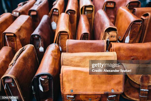 leather bags at the market stall at portobello road market in london, england - leather bag stock pictures, royalty-free photos & images