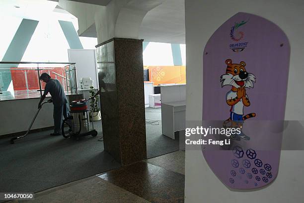 Worker clears the carpet at Talkatora Indoor Stadium ahead of the Delhi 2010 Commonwealth Games, which open this evening, on October 3, 2010 in...