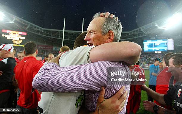 Dragons coach Wayne Bennett embraces one of his players after the NRL Grand Final match between the St George Illawarra Dragons and the Sydney...