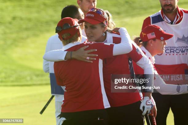 Lexi Thompson of the United States is congratulated by Misuzu Narita of Japan after her side's victory on the 15th hole in the Pool B match between...