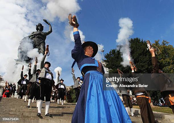 Traditional Bavarian riflemen and -women shoot during a parade in front of the famouse scupture called 'Bavaria' during the Oktoberfest at...