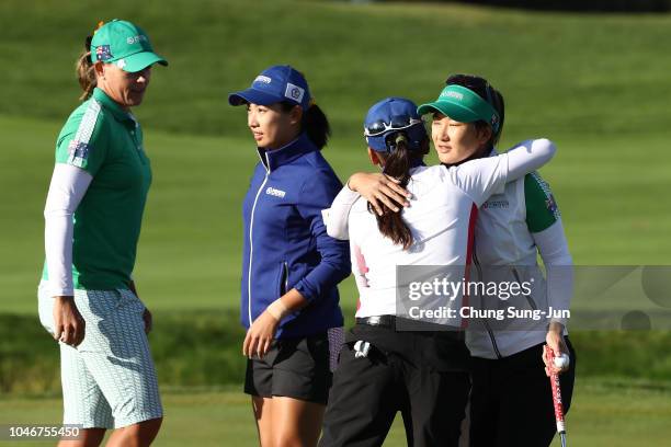 Oh Su and Katherine Kirk of Australia are congratulated by Phoebe Yao and Wei-Ling Hsu of Chinese Taipei after their victory on the 14th green in the...