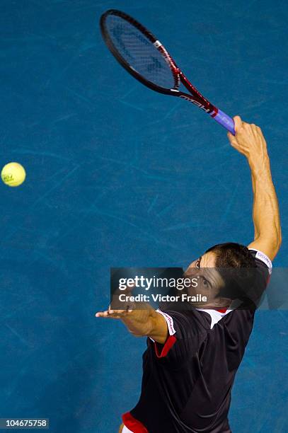 Guillermo Garcia-Lopez of Spain serves against Jarkko Nieminen of Finland in the singles final match on Day 9 of the PTT Thailand Open at Impact...